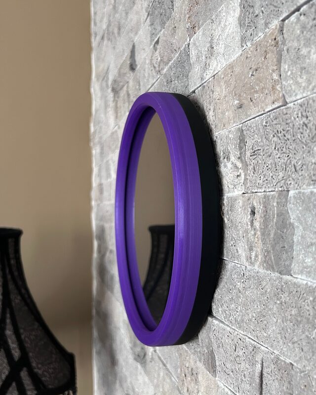 Purple frame infinity mirror on side table with plants