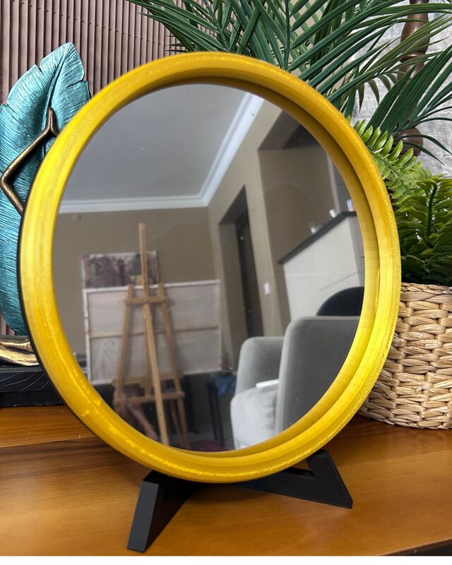 Yellow frame round infinity mirror in a living room corner