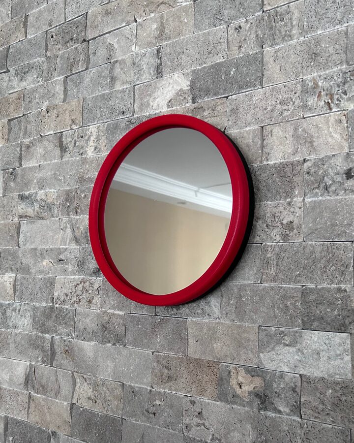 Round LED infinity mirror home decor on stone accent wall